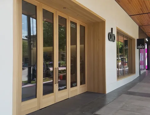 Wood folding doors across a retail storefront.