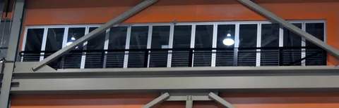 Hurricane aluminum folding glass panels overlooking an interior atrium.