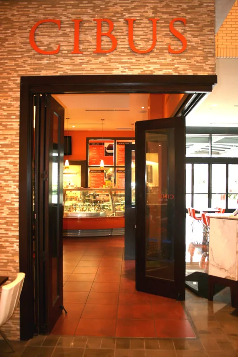 Wood folding doors at a restaurant entrance.