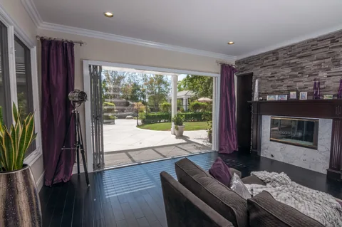 A screen spanning a living-room opening beside a fireplace.
