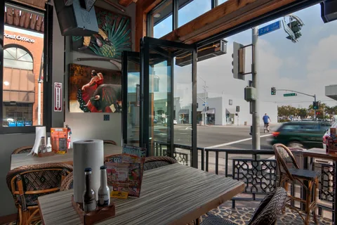 Open folding windows above a restaurant bar counter.