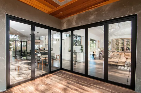 Closed aluminum doors meeting at the corner of a residential deck.