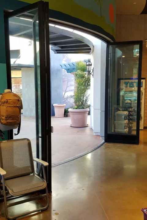 An interior view along a curved folding-door opening.