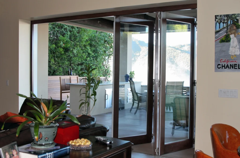 Residential aluminum clad folding patio door system with large glass opening.