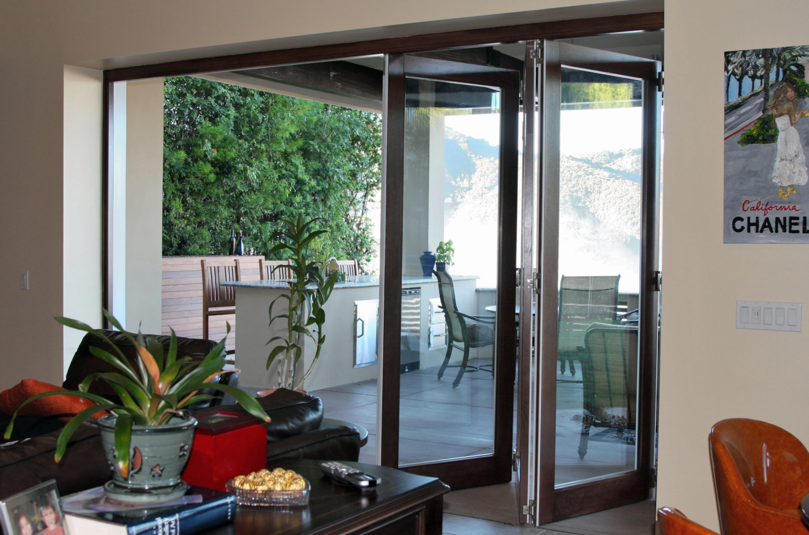 Residential aluminum clad folding patio door system with large glass opening.