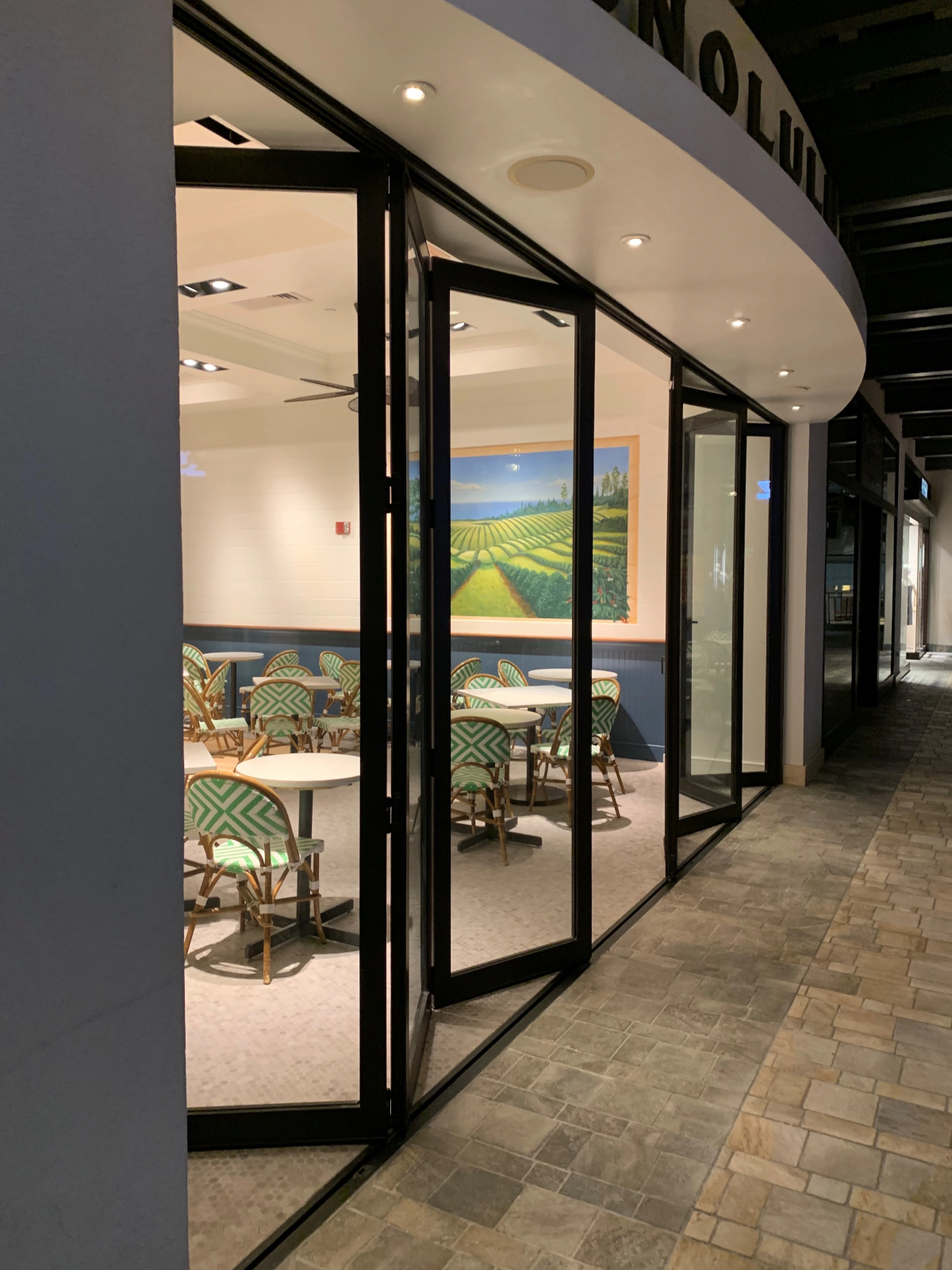 Upscale dining venue featuring elegant commercial glass storefront opening.
