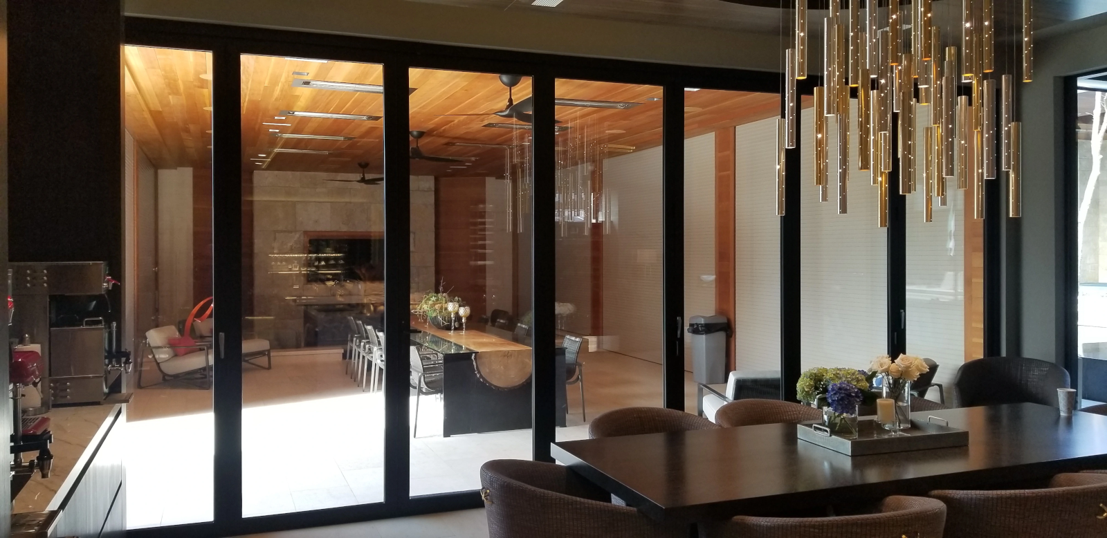 Modern home with bifolding door opening to entertainment space.