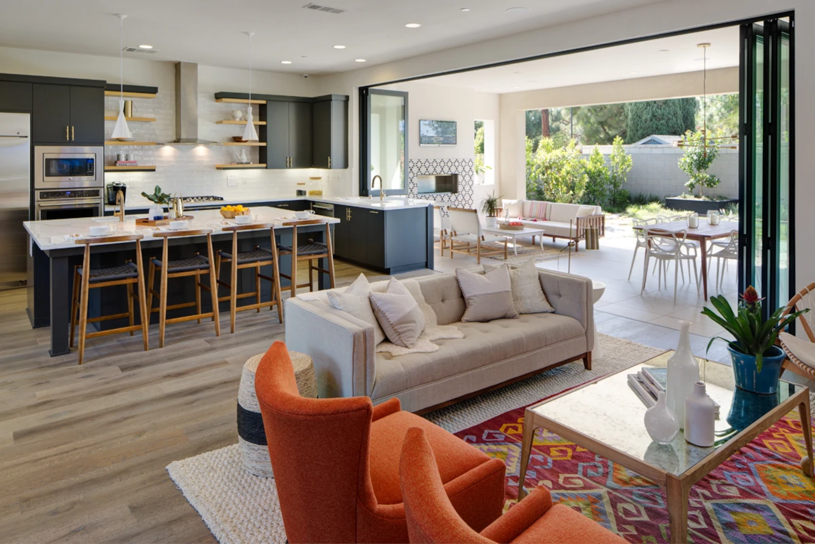 Operable bifolding door and window combination system creating large indoor-outdoor opening.