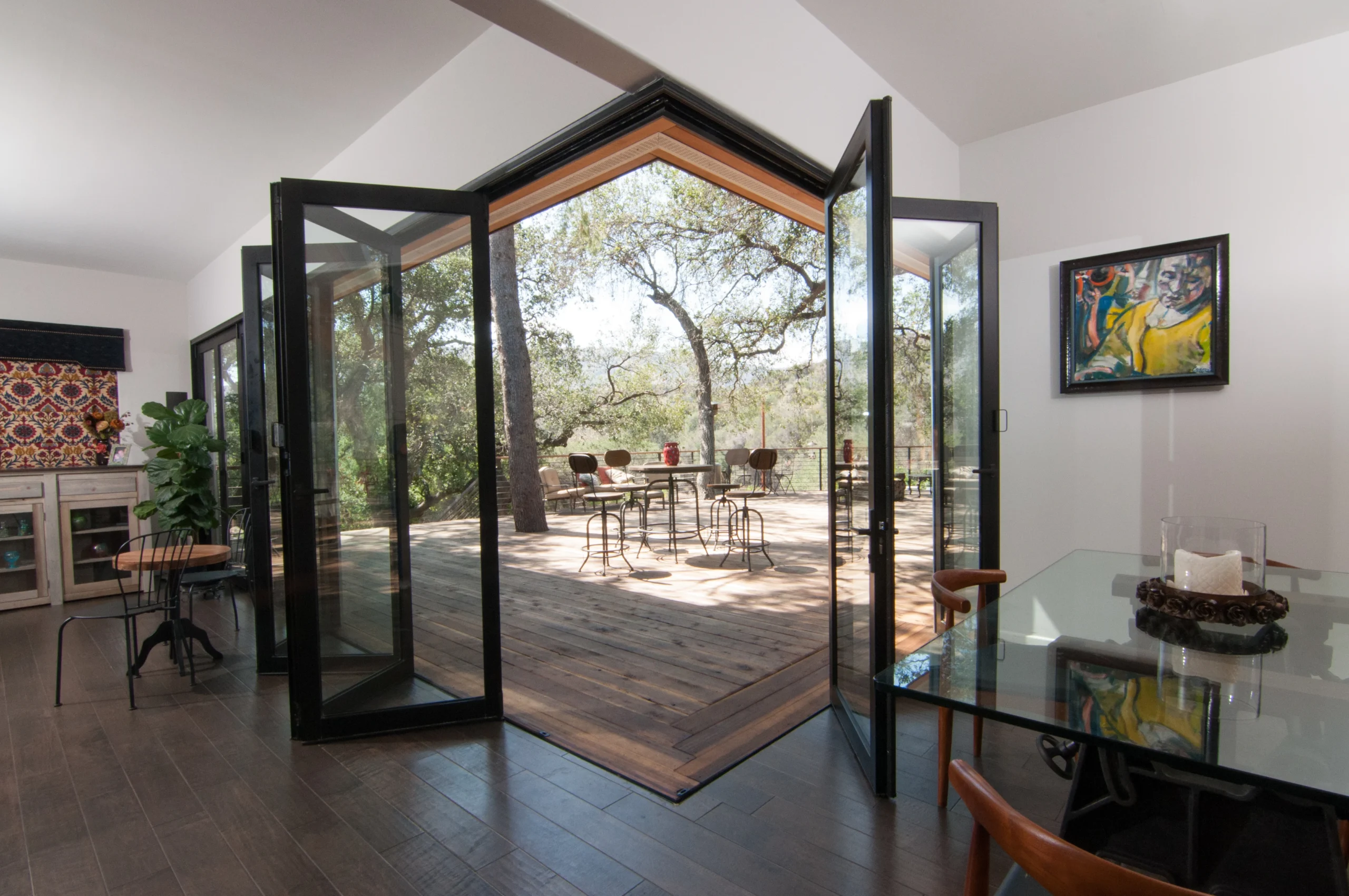 Cornerless folding glass wall system opening luxury home to outdoor patio.