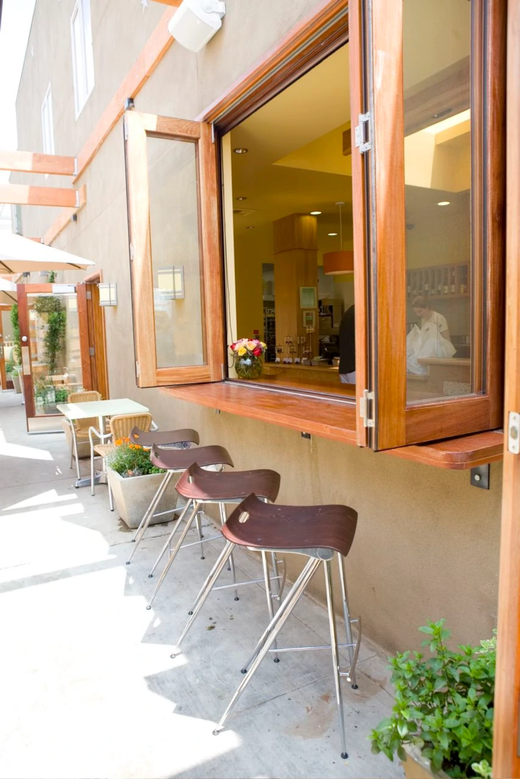 Hospitality pass-through window system with large glass opening.